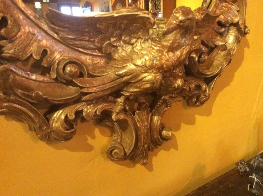 An 18thC carved and gilded oval shaped mirror  View XII