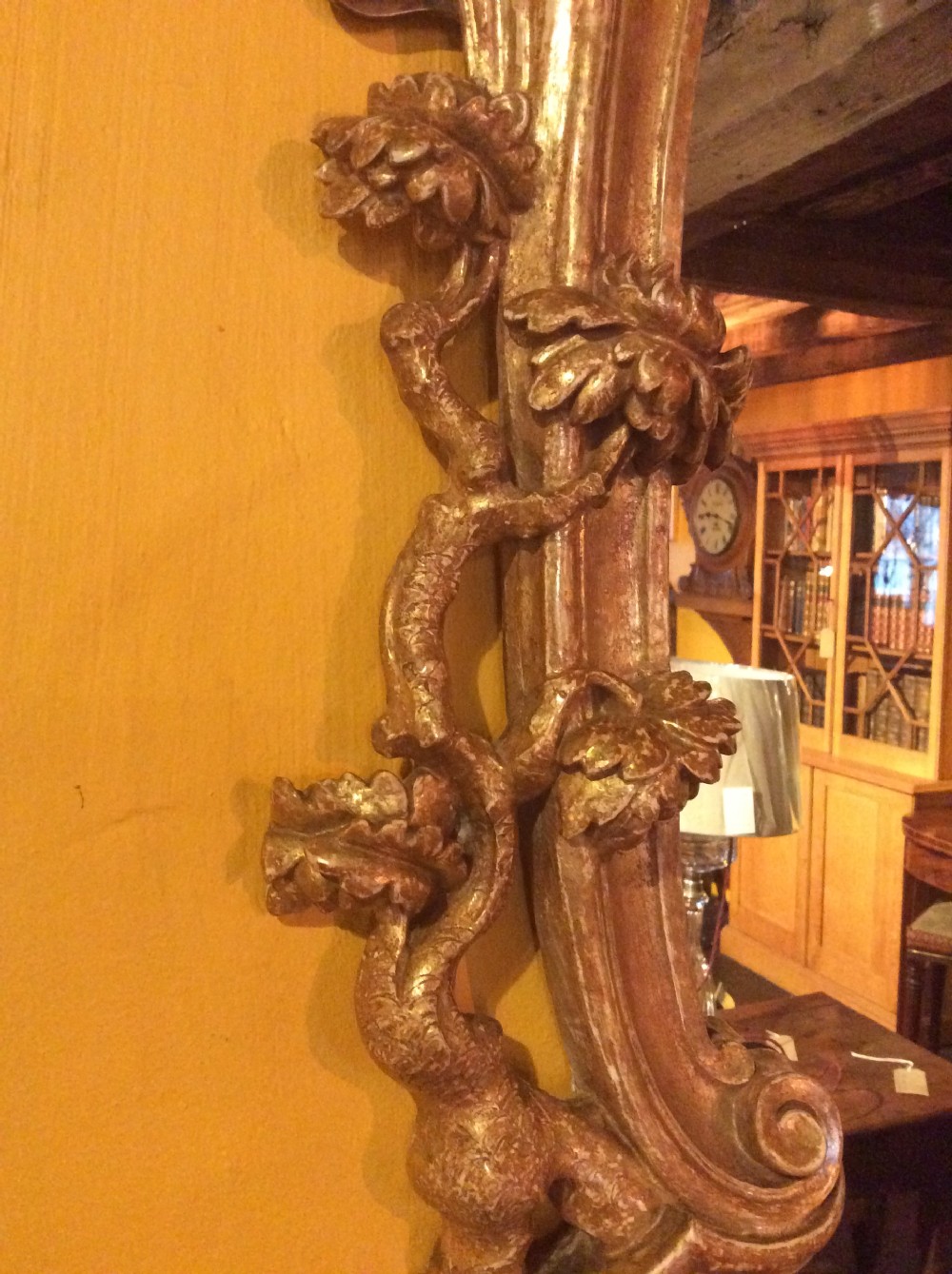 An 18thC carved and gilded oval shaped mirror  View XIII