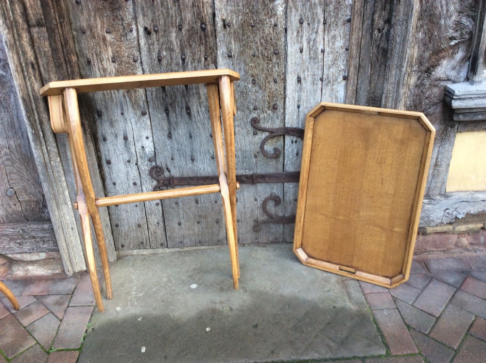 An early twentieth-century light oak butlers tray featuring cut-out handles, resting on a matching curved wooden stand. View II