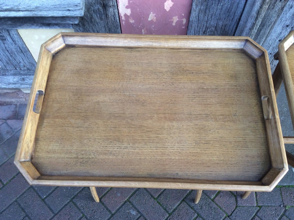 An early twentieth-century light oak butlers tray featuring cut-out handles, resting on a matching curved wooden stand. View IV