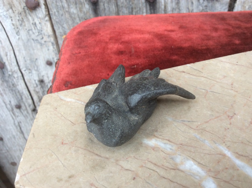 A dark bronze sculpture depicting a hunting dog stalked towards a small bird, mounted on a cream marble plinth. View V