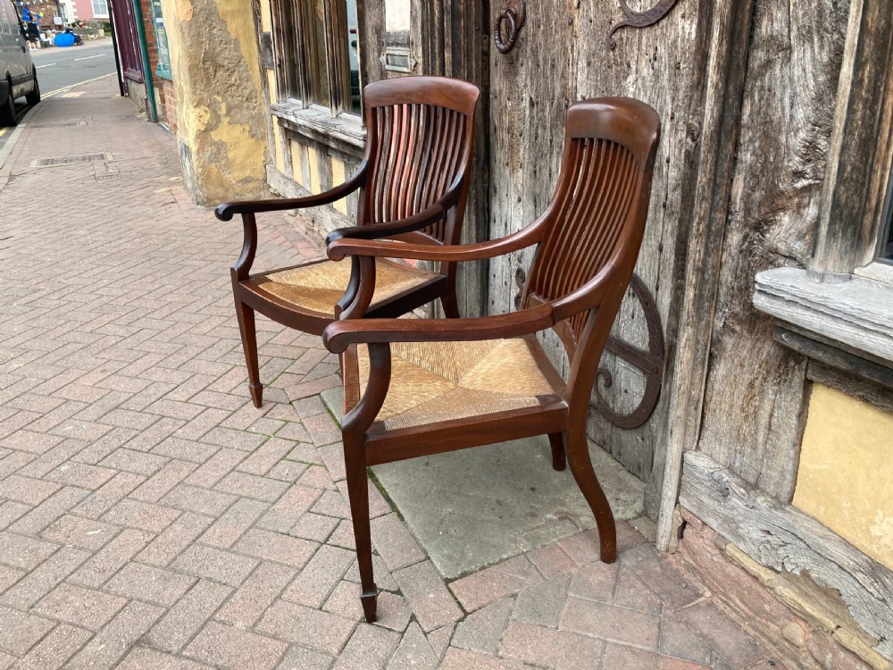 A pair of early 20th century mahogany rush-seated armchairs c 1910 View II