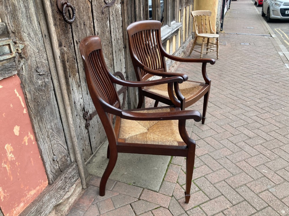 A pair of early 20th century mahogany rush-seated armchairs c 1910 View III