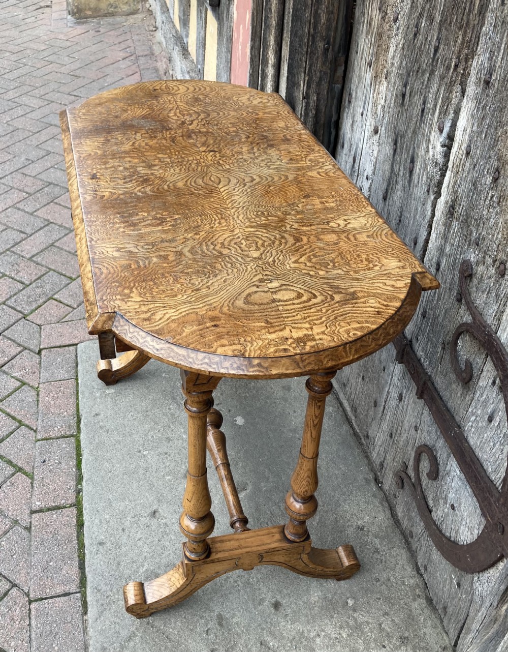 A 19th-century Hungarian ash side table featuring a single drawer with a dark knob, shaped aprons, and turned legs joined by a central stretcher. View VII