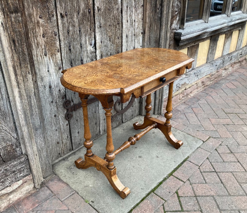 A 19th-century Hungarian ash side table featuring a single drawer with a dark knob, shaped aprons, and turned legs joined by a central stretcher. View III