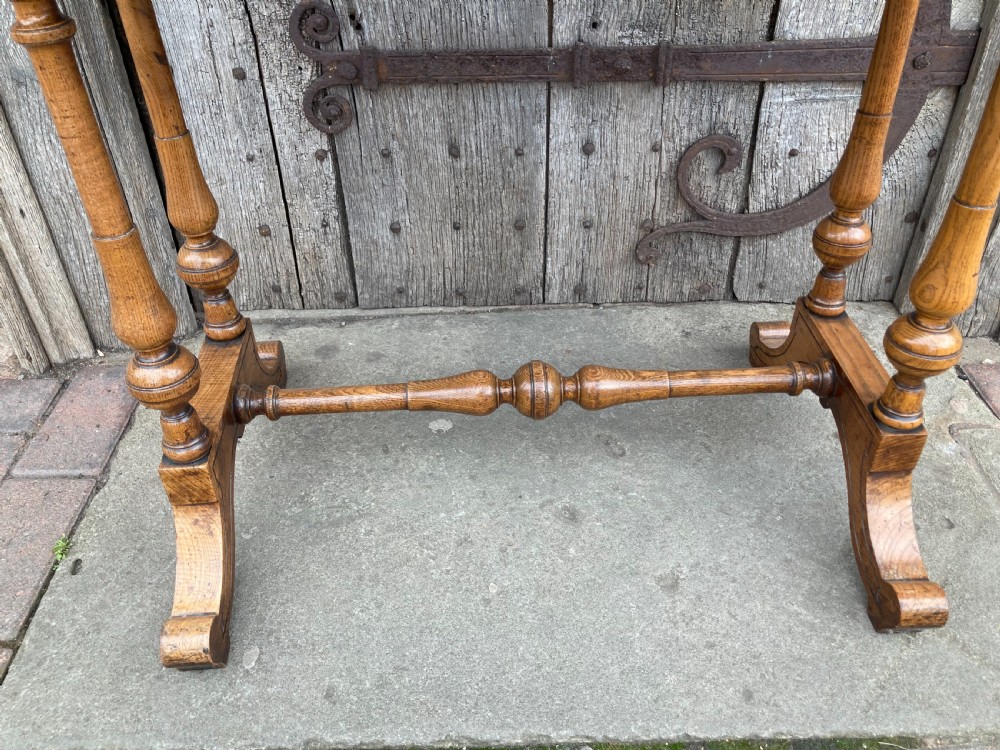 A 19th-century Hungarian ash side table featuring a single drawer with a dark knob, shaped aprons, and turned legs joined by a central stretcher. View VI