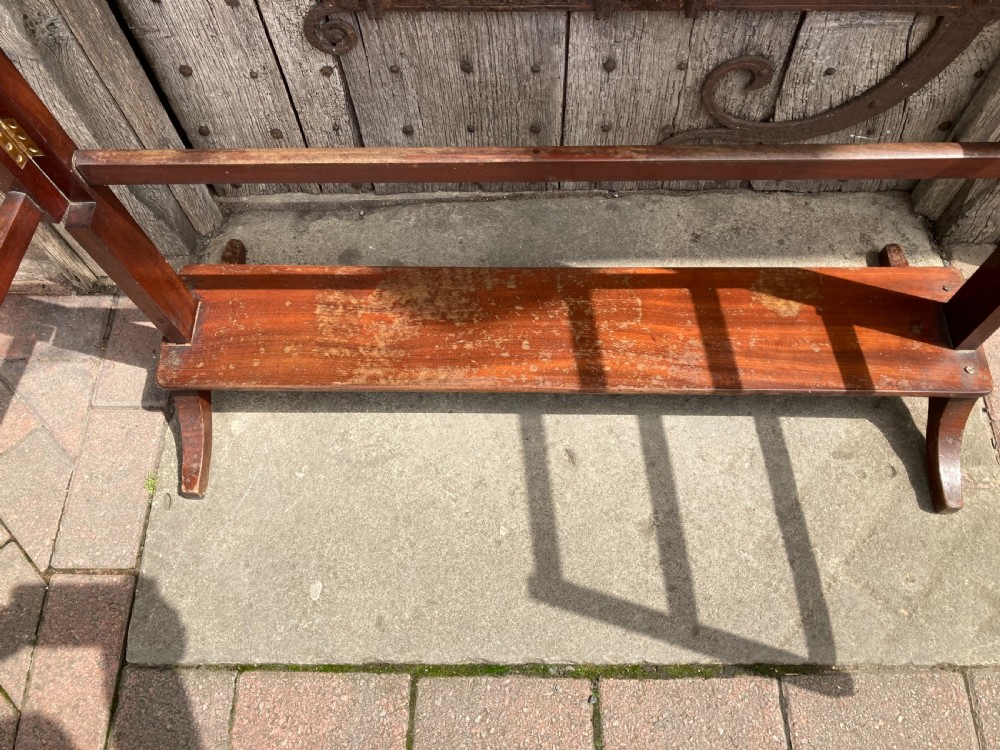 A nineteenth-century mahogany three-fold towel rail featuring horizontal drying bars, brass hinges, and a solid lower wooden shelf. View III