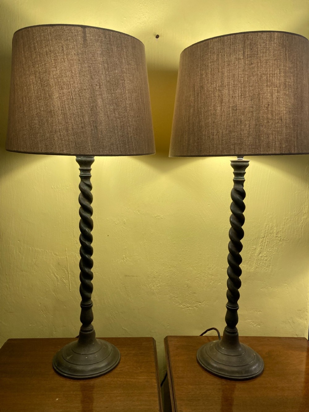 A pair of 19th century tall, twisted column, patinated brass table lamps