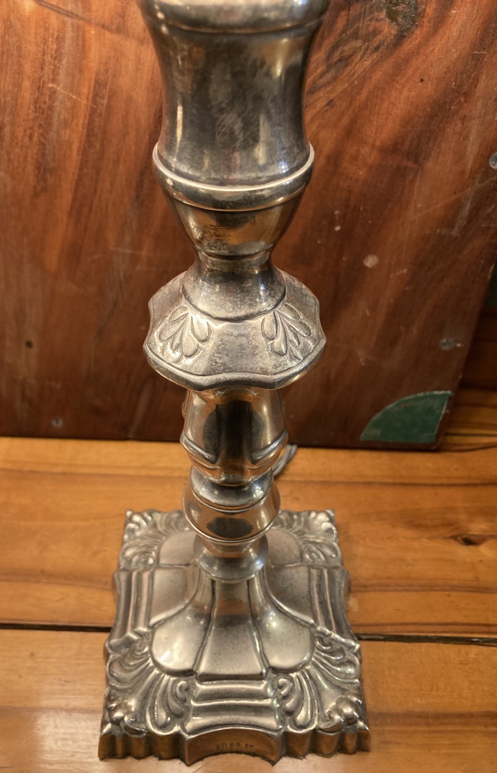 A pair of early twentieth-century silver-plated candlestick table lamps fitted with red pleated shades. View III