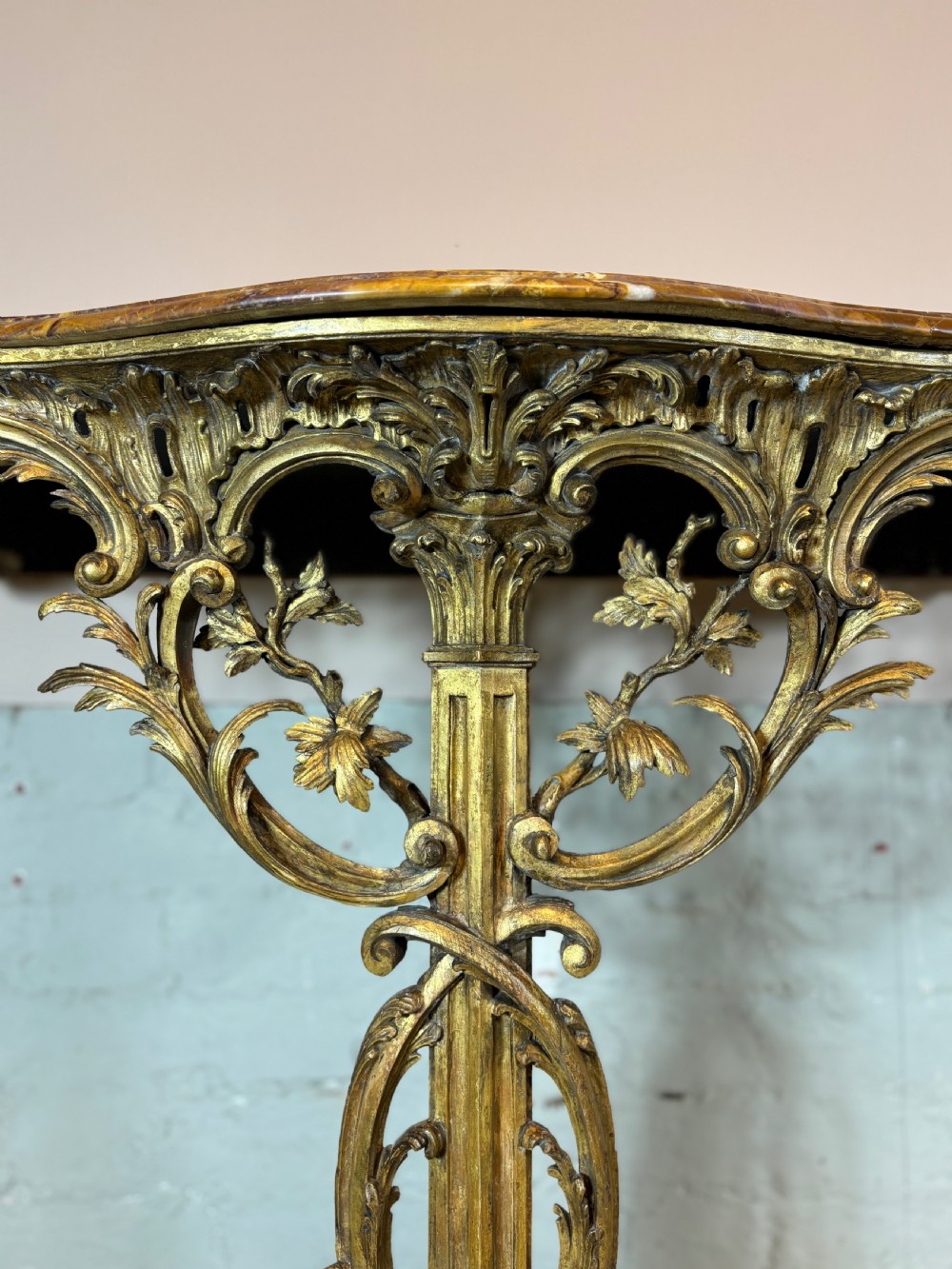 A pair of 18th-century carved giltwood side tables with openwork scrolling pedestal bases and marble tops. View VIII