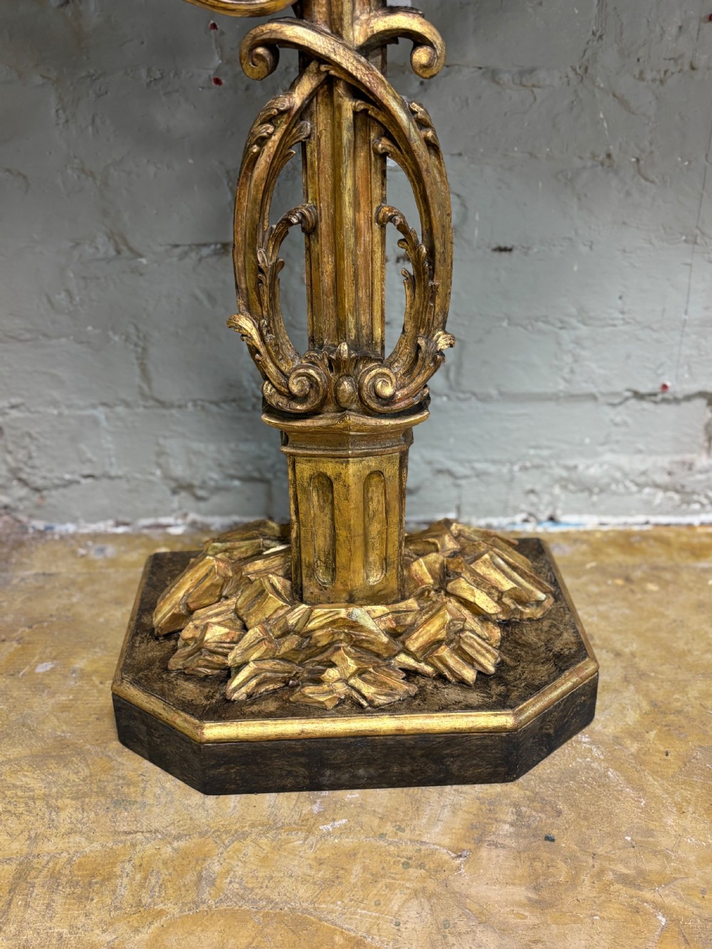 A pair of 18th-century carved giltwood side tables with openwork scrolling pedestal bases and marble tops. View XV