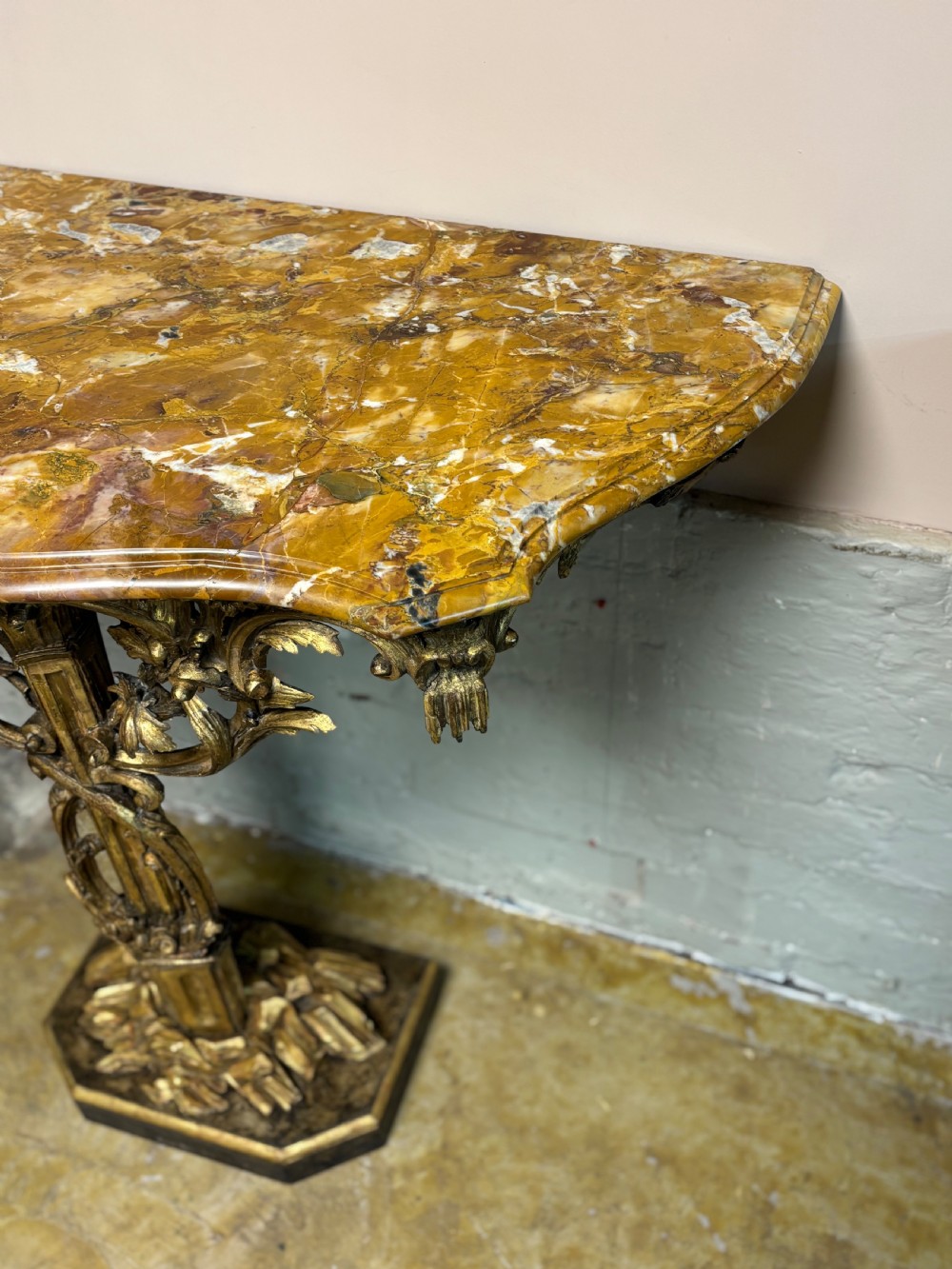 A pair of 18th-century carved giltwood side tables with openwork scrolling pedestal bases and marble tops. View XVI