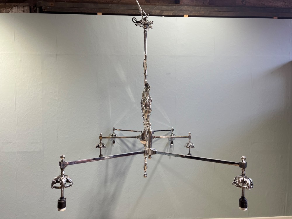 A 19th-century six-branch billiard light with a decorative silver-toned metal scrollwork frame supporting six pleated fabric conical shades. View II