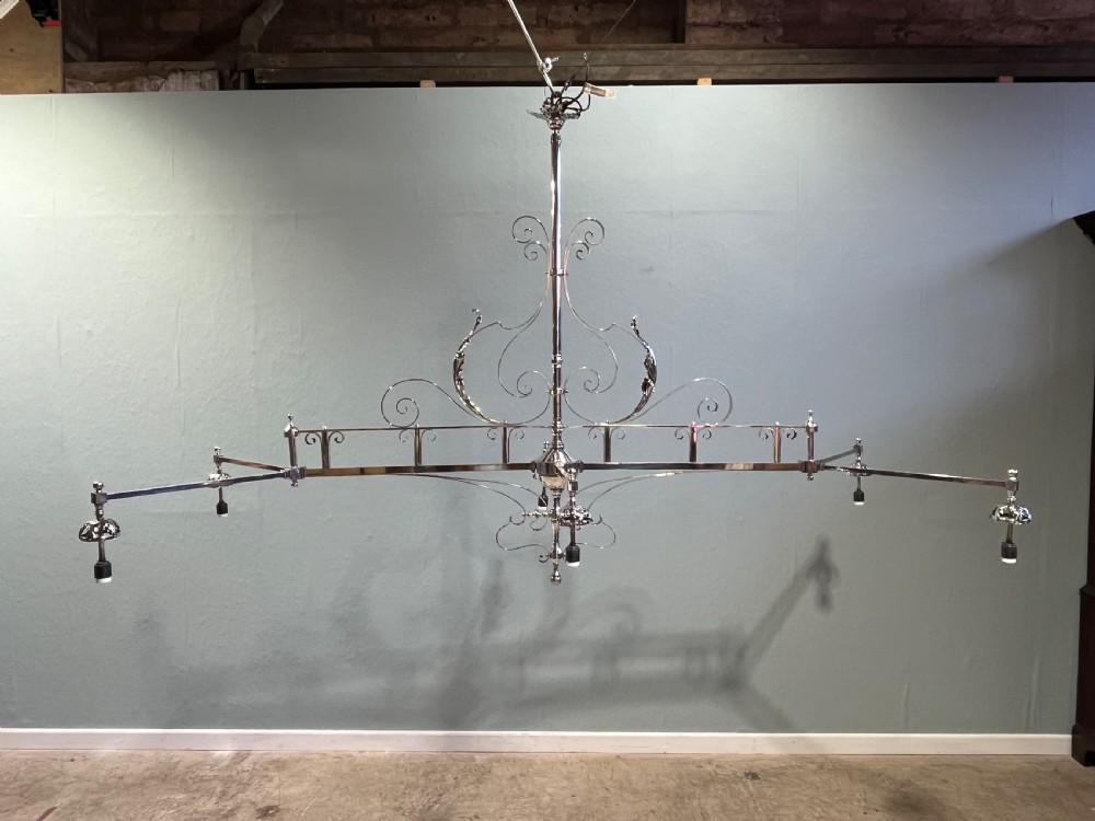 A 19th-century six-branch billiard light with a decorative silver-toned metal scrollwork frame supporting six pleated fabric conical shades. View IX