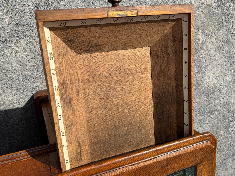 A 19th-century oak partners desk featuring a green leather inset top, two pedestals with multiple drawers, and carved wooden handles. View II