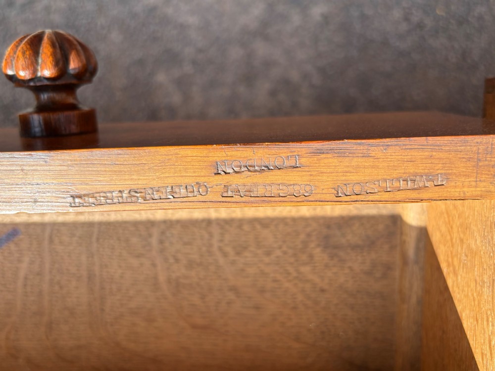 A 19th-century oak partners desk featuring a green leather inset top, two pedestals with multiple drawers, and carved wooden handles. View III