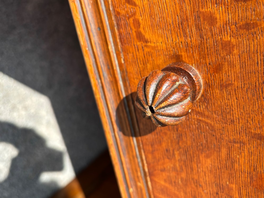 A 19th-century oak partners desk featuring a green leather inset top, two pedestals with multiple drawers, and carved wooden handles. View VIII