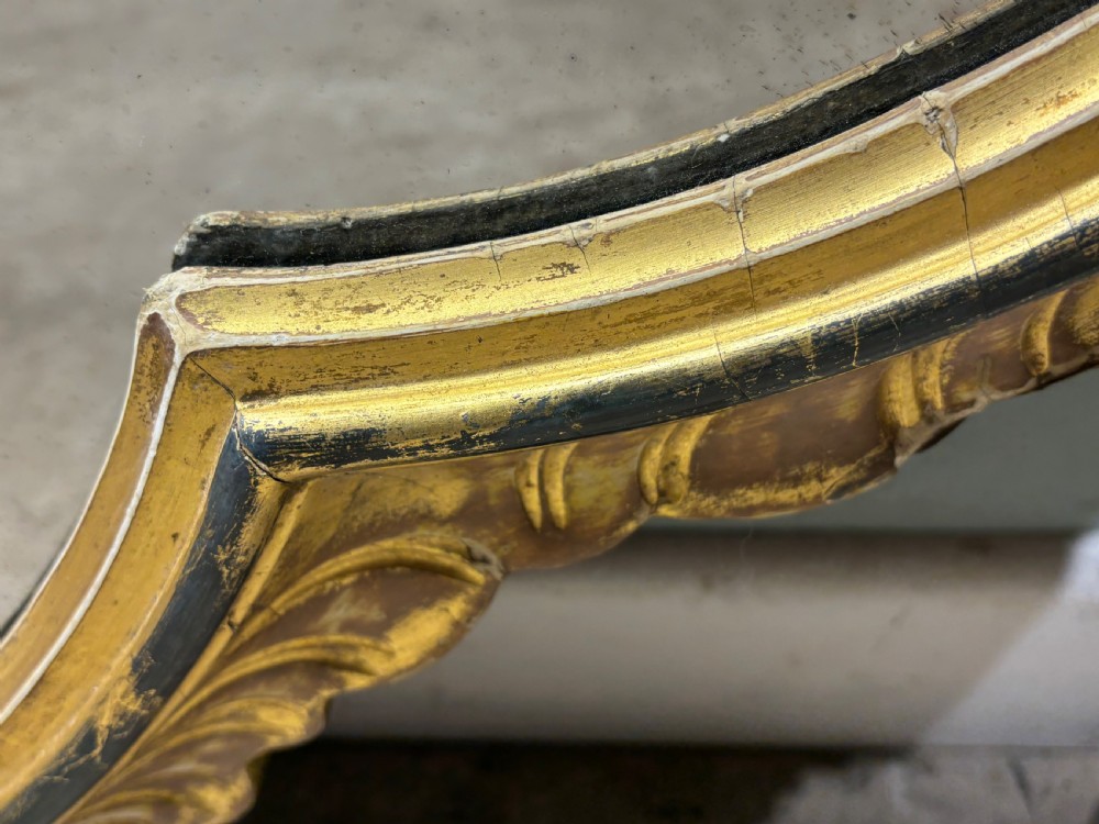 A large nineteenth-century giltwood wall mirror featuring a lobed quatrefoil shape and a moulded outer rim. View VI