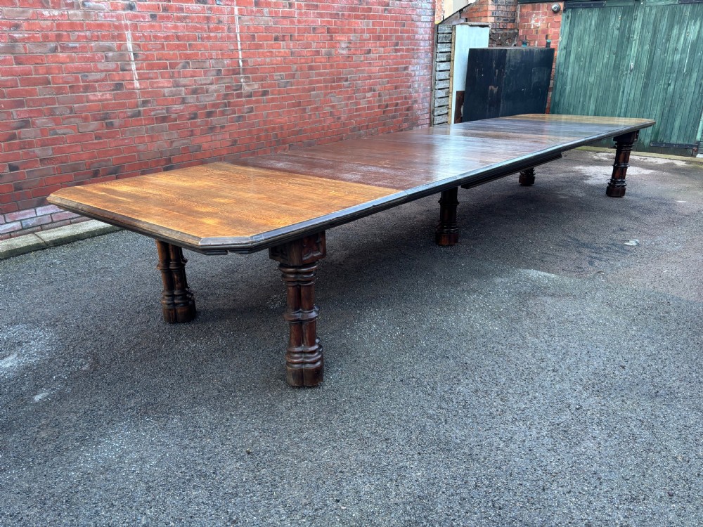 An 18-foot long 19th-century Gothic Revival solid oak table featuring carved clustered column legs and a plank top. View VII