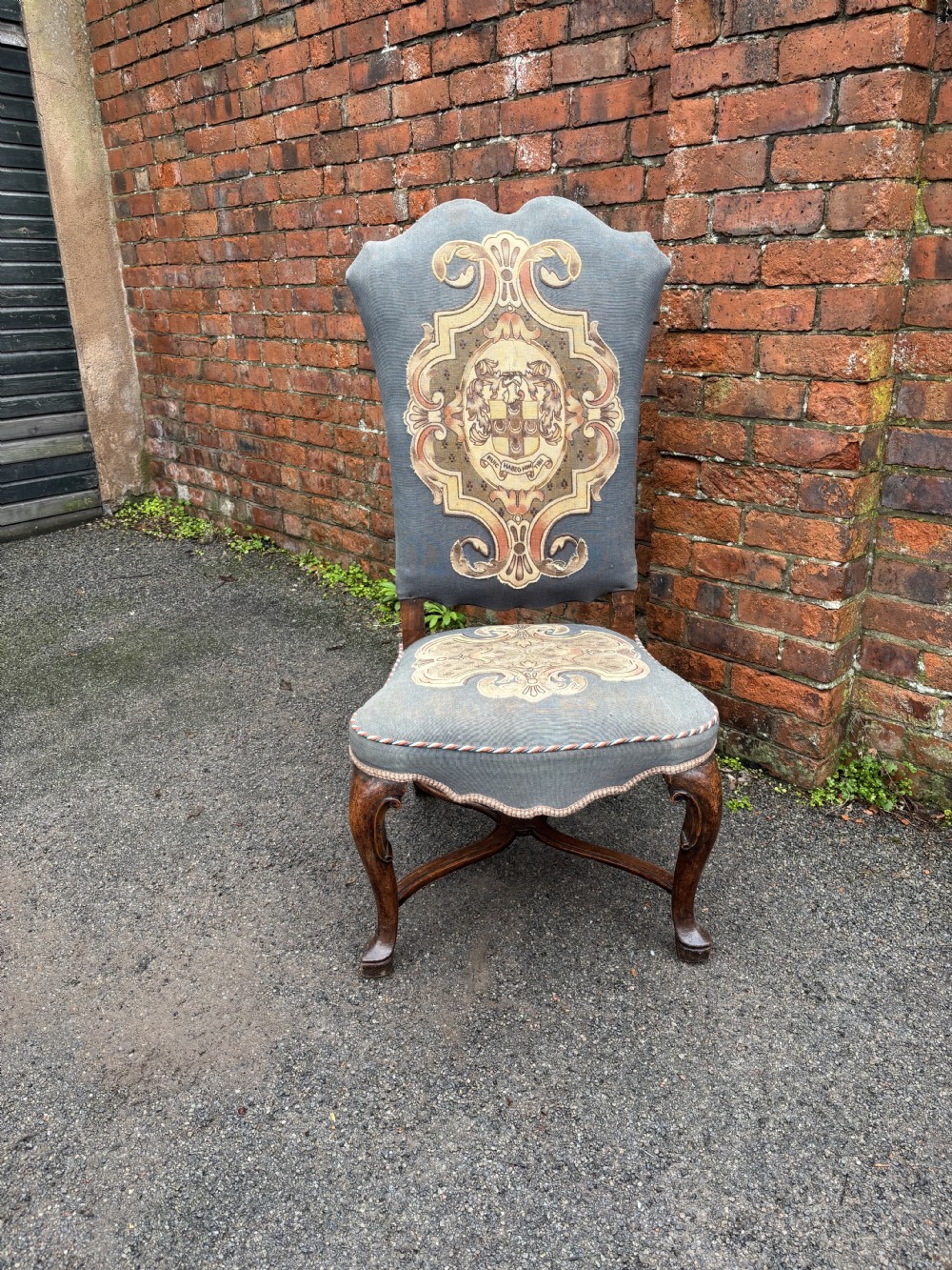 A set of six 18th-century Italian walnut dining chairs with tall backrests upholstered in grey fabric featuring central embroidered figural panels and cabriole legs. View II