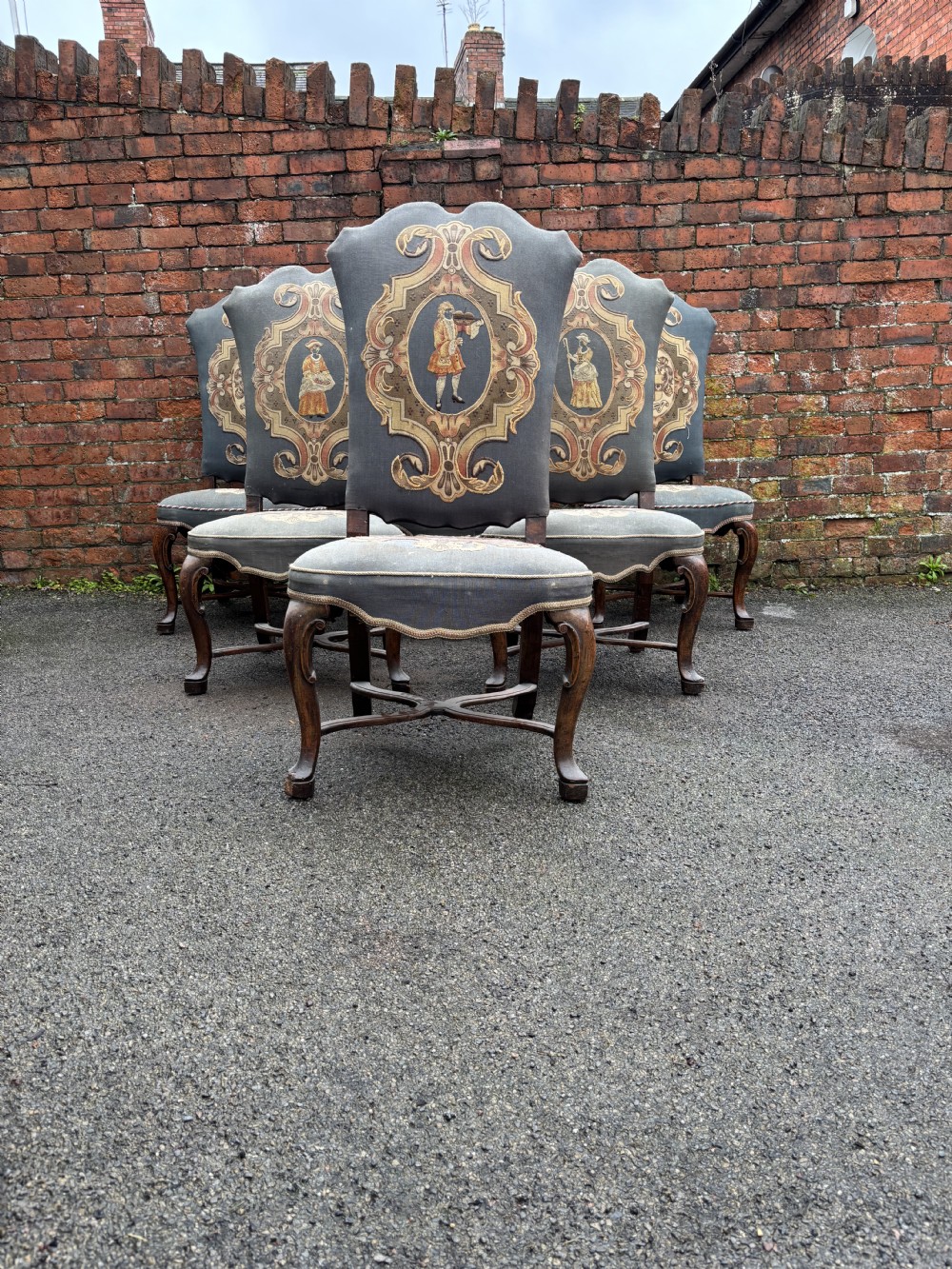 A set of six 18th-century Italian walnut dining chairs with tall backrests upholstered in grey fabric featuring central embroidered figural panels and cabriole legs. View III