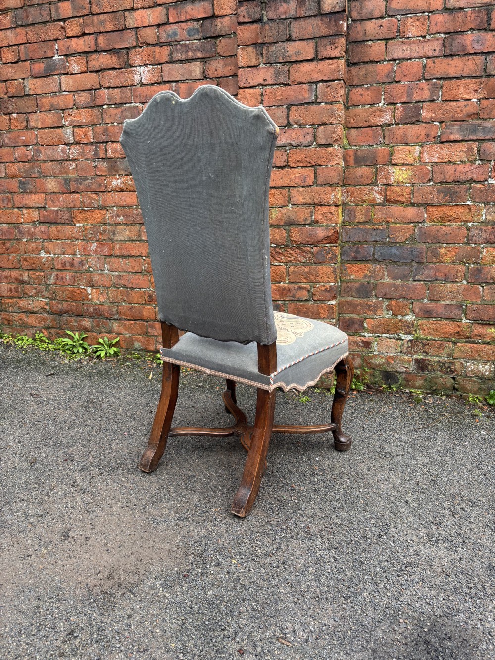 A set of six 18th-century Italian walnut dining chairs with tall backrests upholstered in grey fabric featuring central embroidered figural panels and cabriole legs. View V