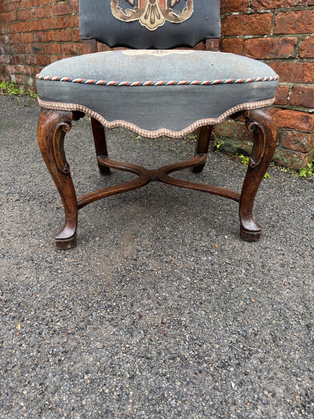 A set of six 18th-century Italian walnut dining chairs with tall backrests upholstered in grey fabric featuring central embroidered figural panels and cabriole legs. View VI