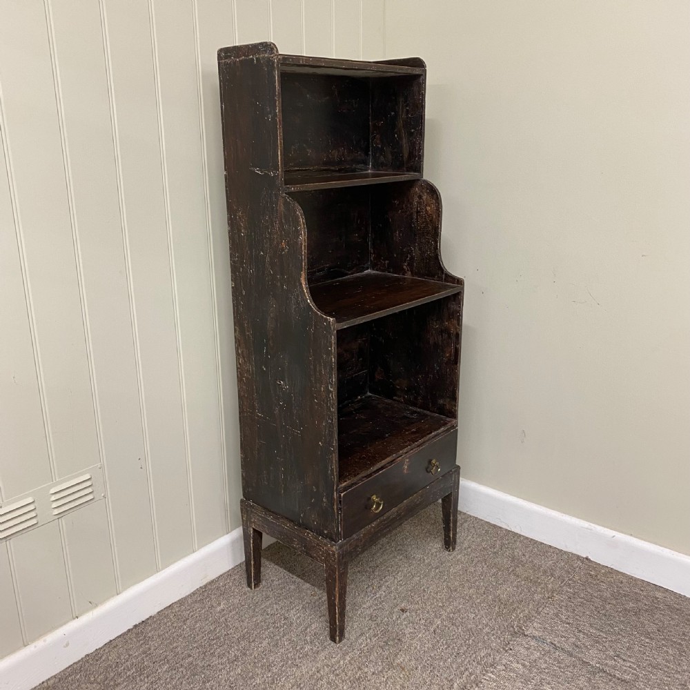 A tall, narrow dark brown Regency waterfall bookcase featuring open graduated shelves above a single drawer with brass drop handles. View II