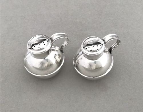 fig 1. A novelty pair of silver 'Guernsey cream jug' pepper pots
