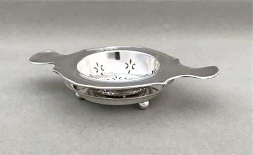 fig 1. A gorgeous silver tea strainer and drip stand