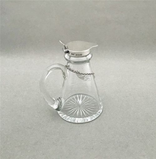 fig 1. A lovely silver mounted Whisky tot with original silver label