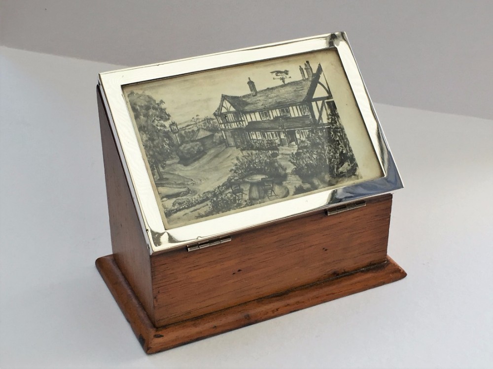 An Unusual Stationary Box and silver photo frame combo