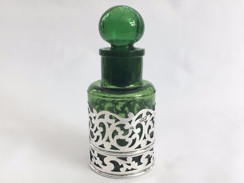 A stunning Victorian pierced silver bottle holder.