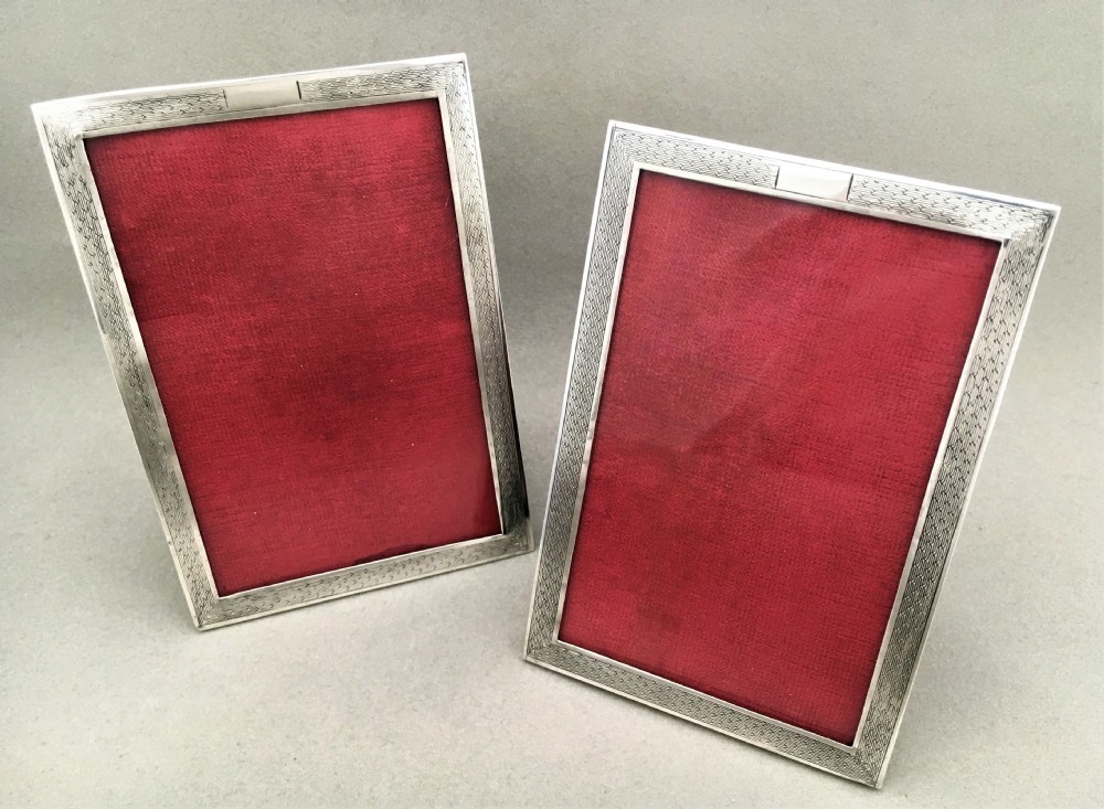 A matching pair of silver engine turned photo frames