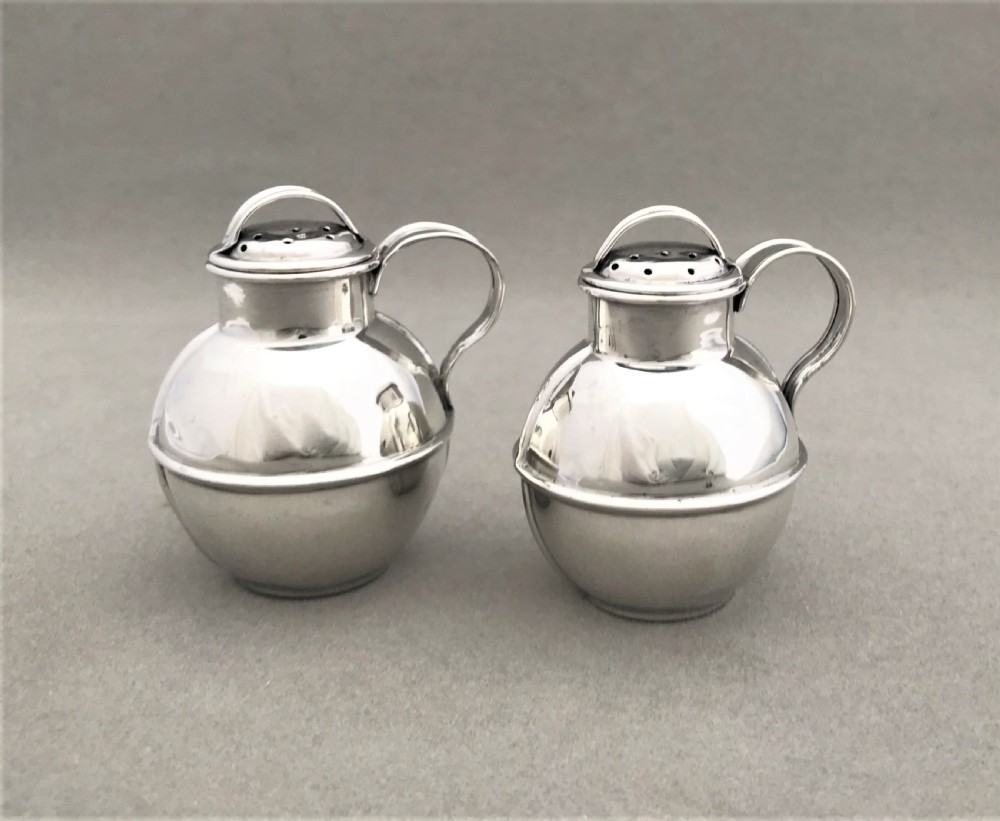 A novelty pair of silver 'Guernsey cream jug' pepper pots
