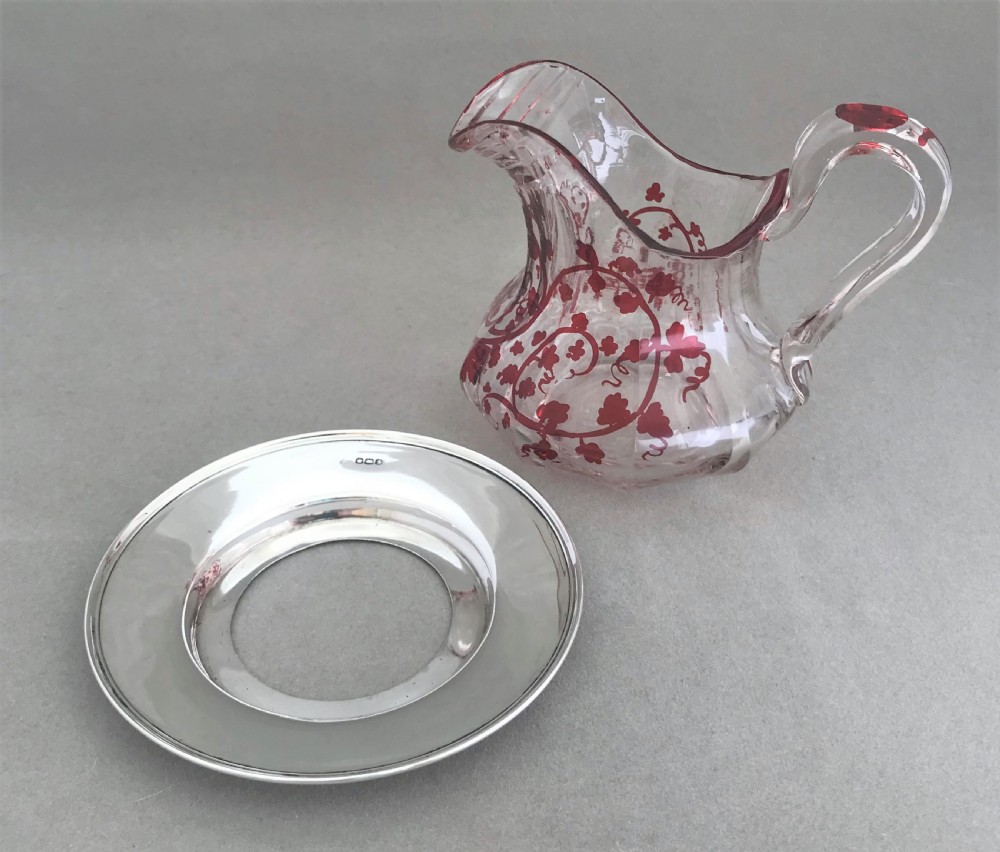 A gorgeous cut glass cream jug with silver drip saucer View IV