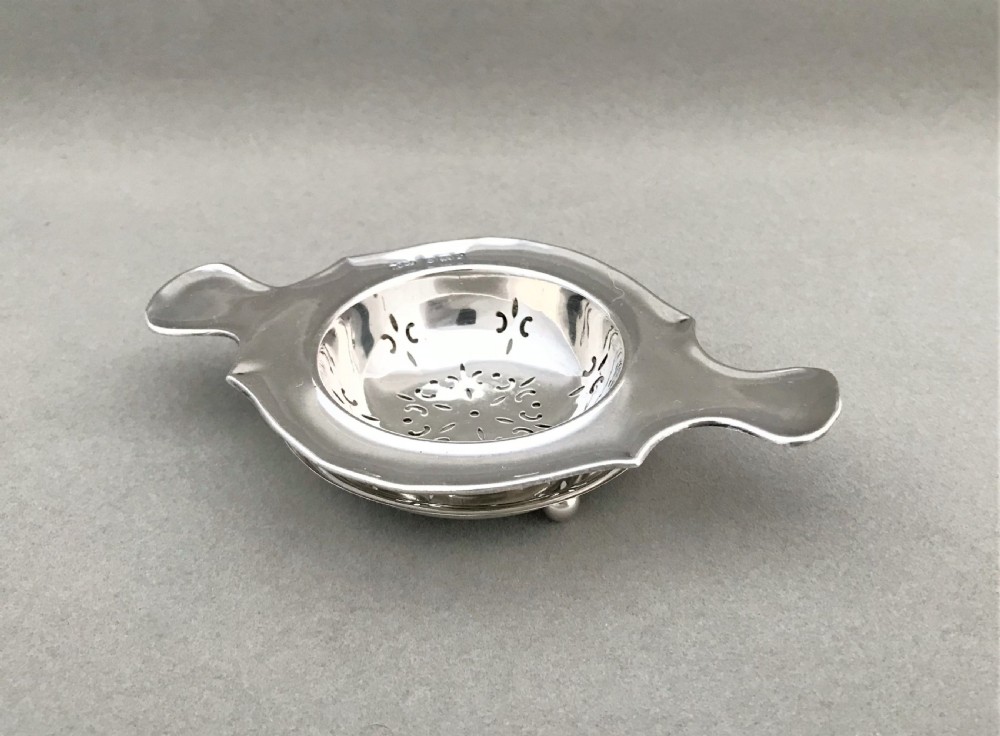 A gorgeous silver tea strainer and drip stand