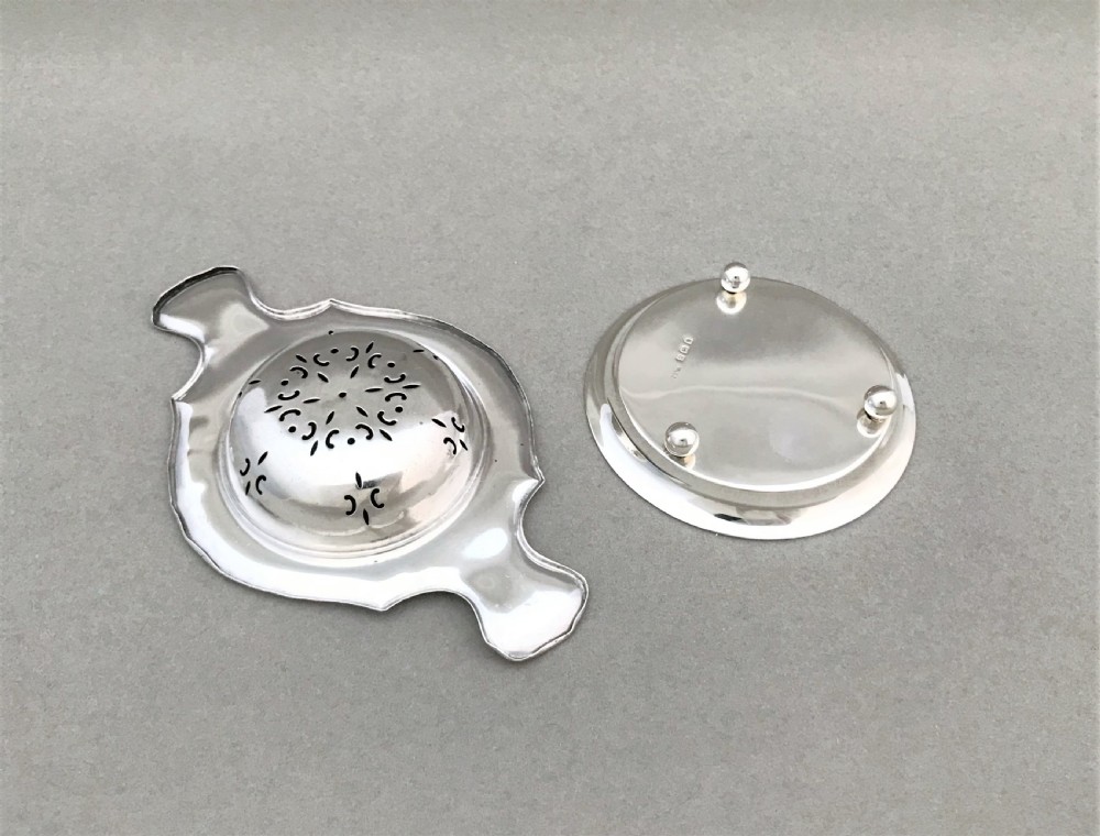 A gorgeous silver tea strainer and drip stand View V