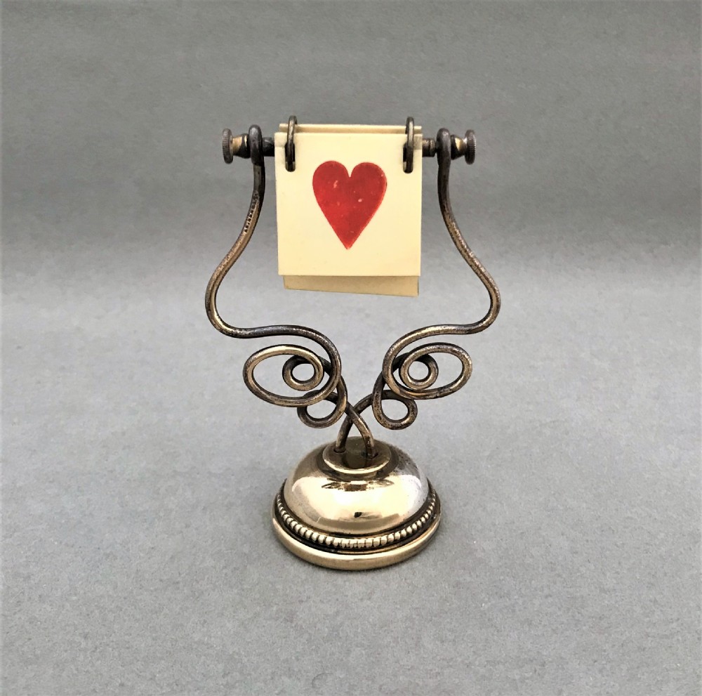A gorgeous Art Nouveau Brass trump marker
