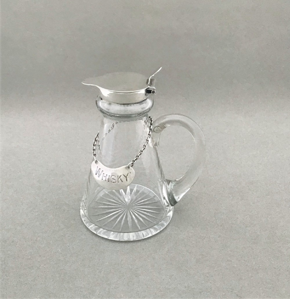 A lovely silver mounted Whisky tot with original silver label