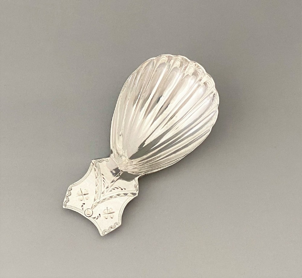 A charming Georgian bright cut silver caddy spoon