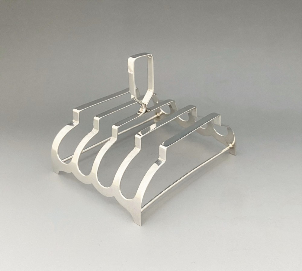 A most unusual Art Deco silver four slice toast rack
