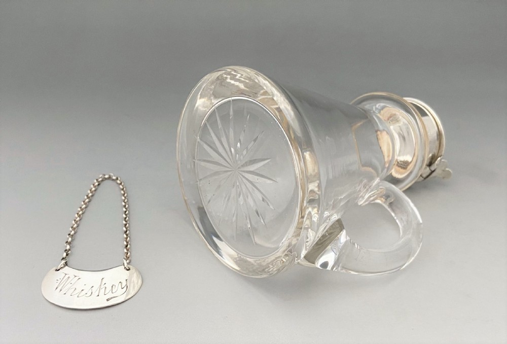 A handsome silver Whisky tot with silver label View V