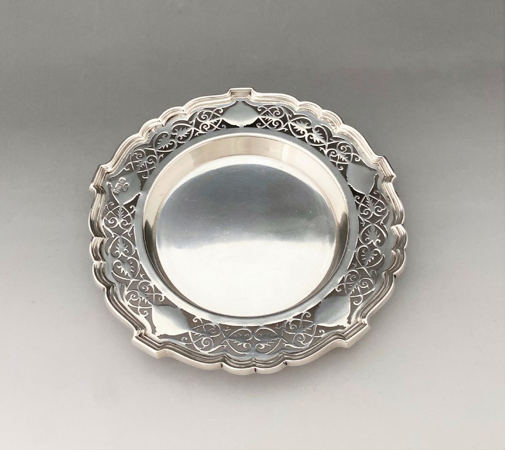 A superb Edwardian silver bottle/decanter coaster