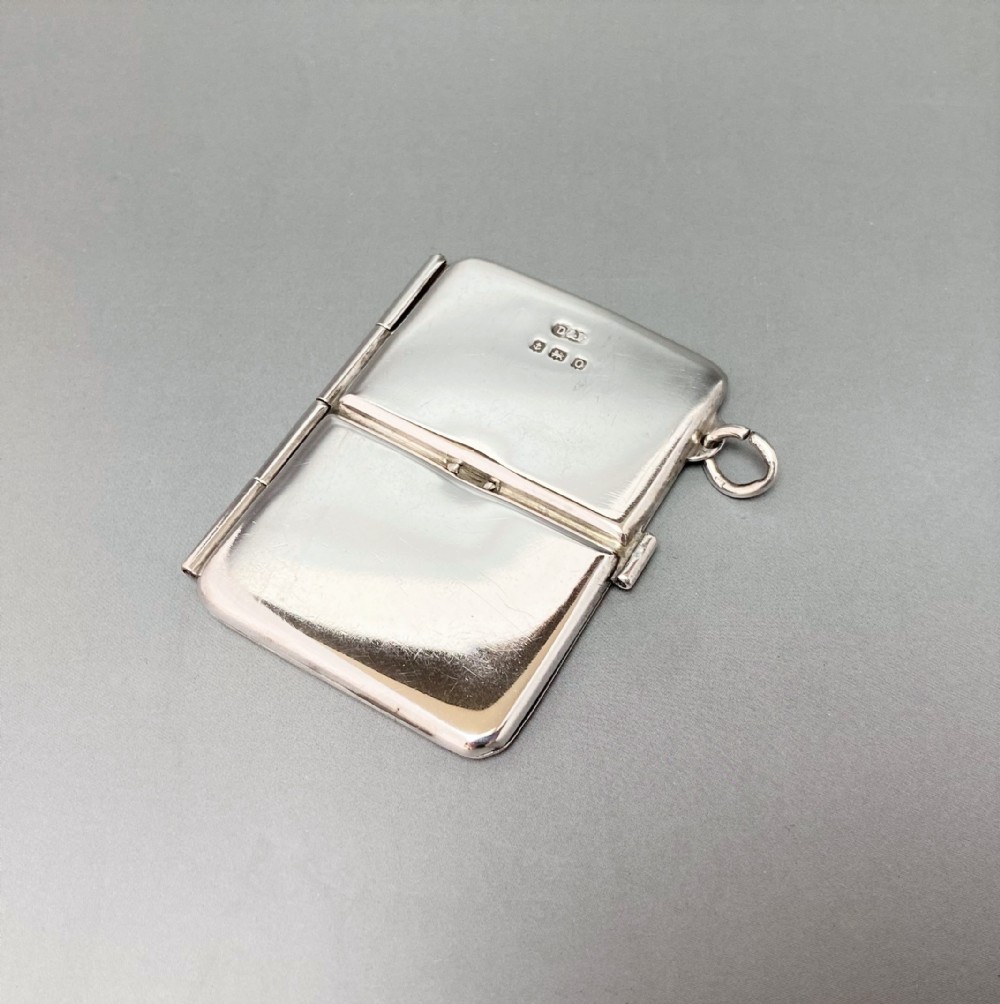 An unusual, hinged silver double stamp case