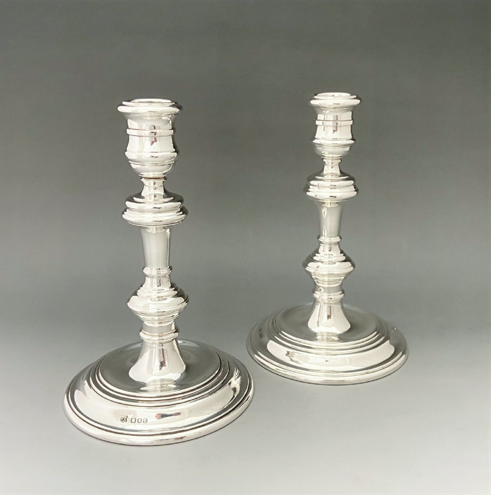 A handsome pair of George I style silver candlesticks