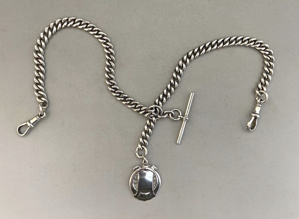A wonderful George V silver Albert chain with silver fob