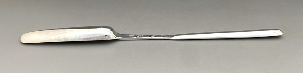 A long, slender George II sterling silver marrow scoop featuring a wide channelled scoop at one end and a narrower trough at the opposite end. View IV