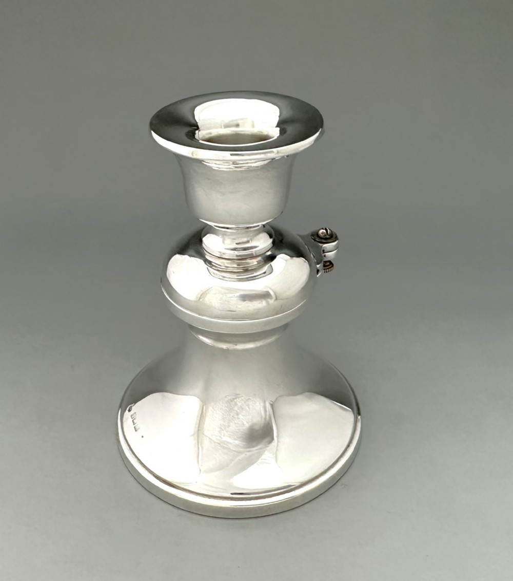 An unusual silver inkwell/ candle holder combo