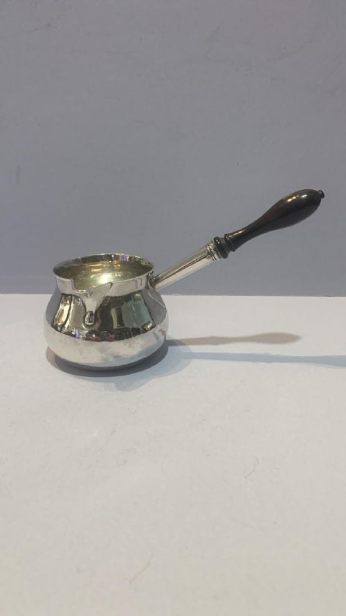 AN ANTIQUE SILVER BRANDY WARMER